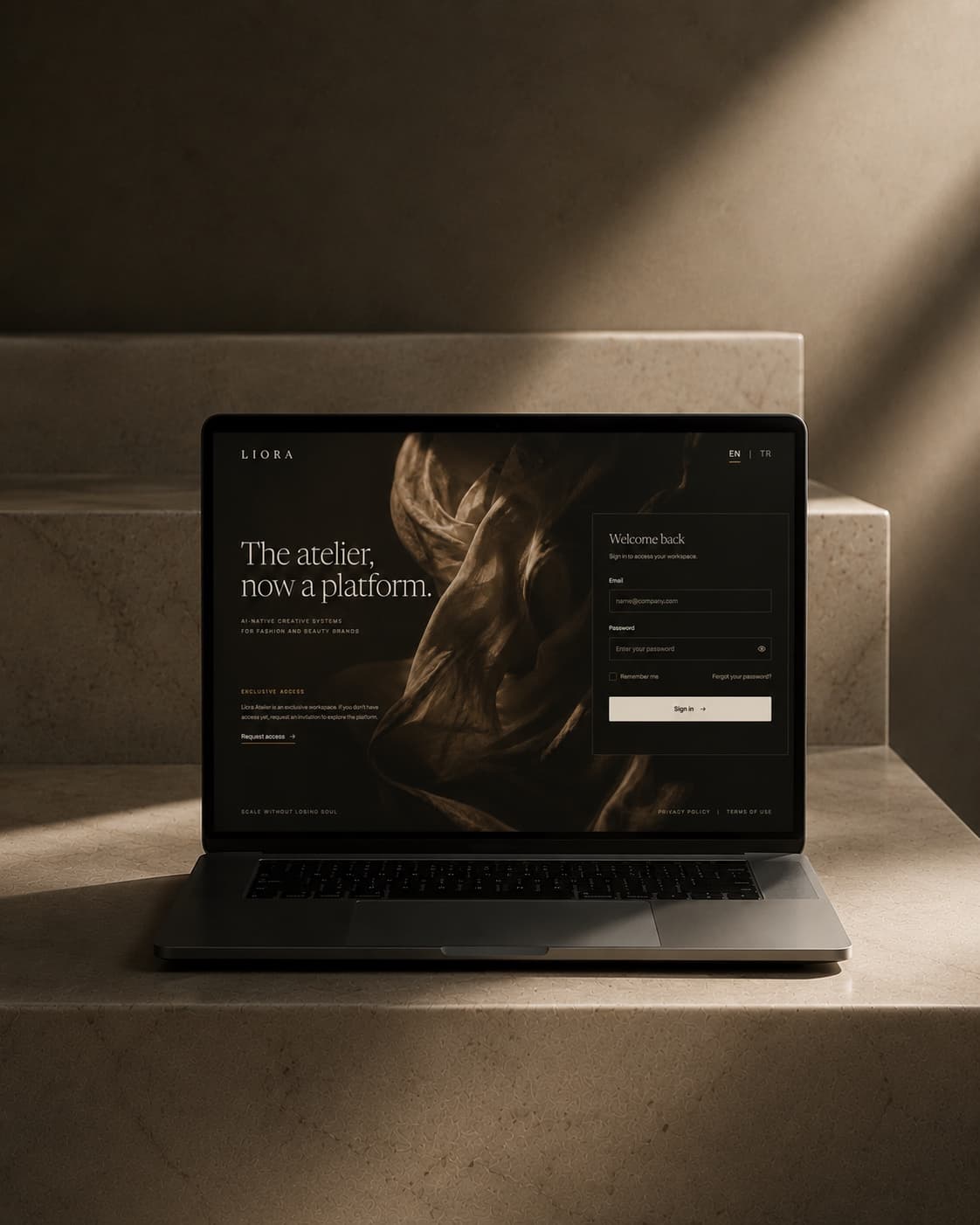 The Liora Atelier platform — a laptop on stone steps showing an editorial brand website